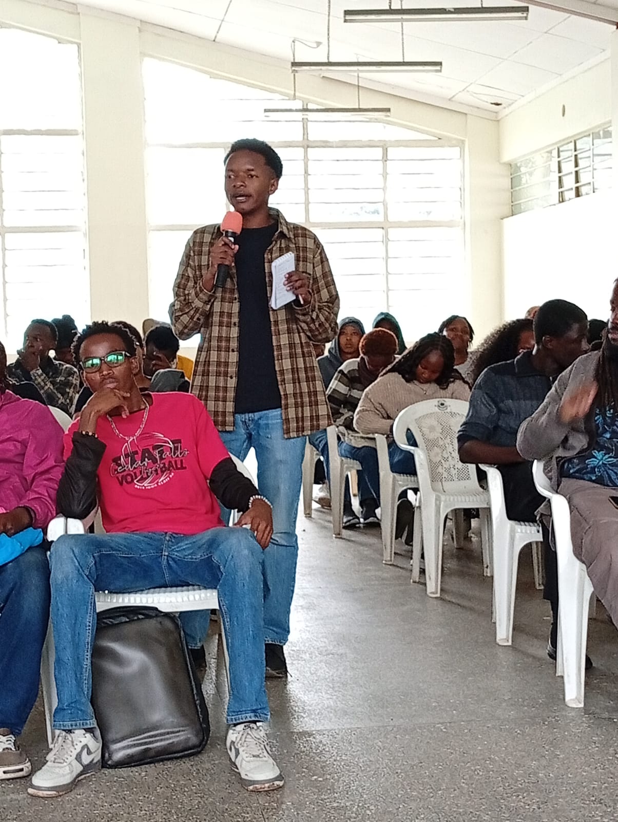 A student interacts with the speakers during the Q&A session