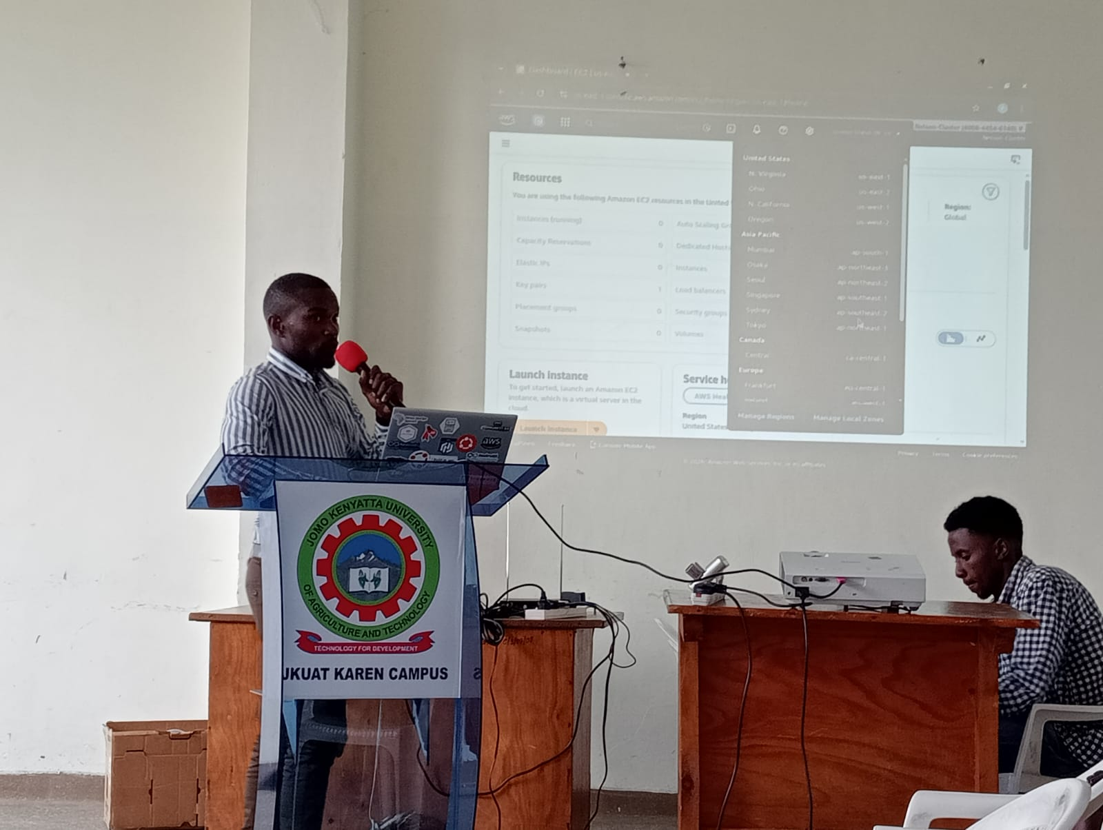 Speaker presenting an AWS console walkthrough at the Assembly Hall