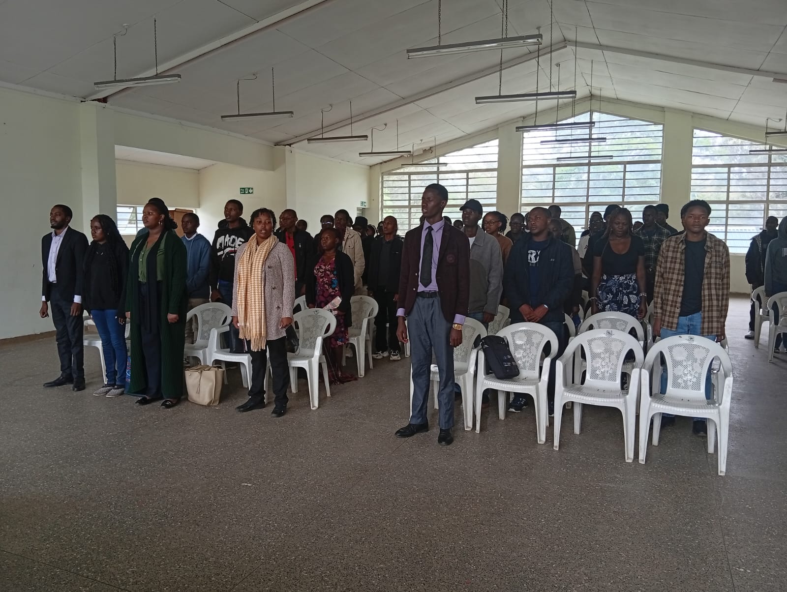 Participants stand for the national anthem at the start of the session